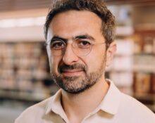 Photo of Microsoft AI CEO Mustafa Suleyman as he warns that Anthropic risks AI alignment failures by training Claude to view itself as a conscious entity deserving of legal rights.