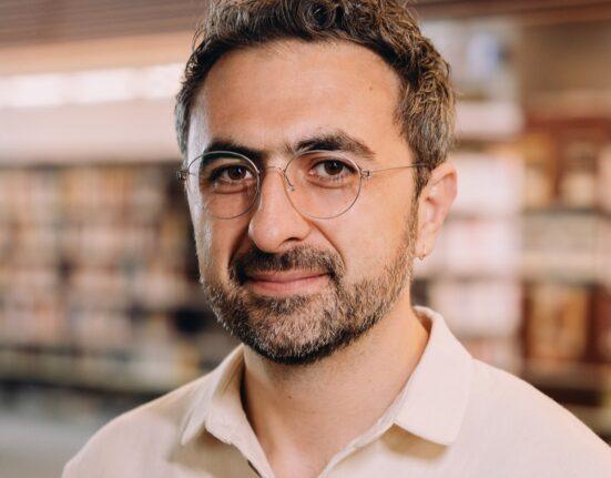 Photo of Microsoft AI CEO Mustafa Suleyman as he warns that Anthropic risks AI alignment failures by training Claude to view itself as a conscious entity deserving of legal rights.
