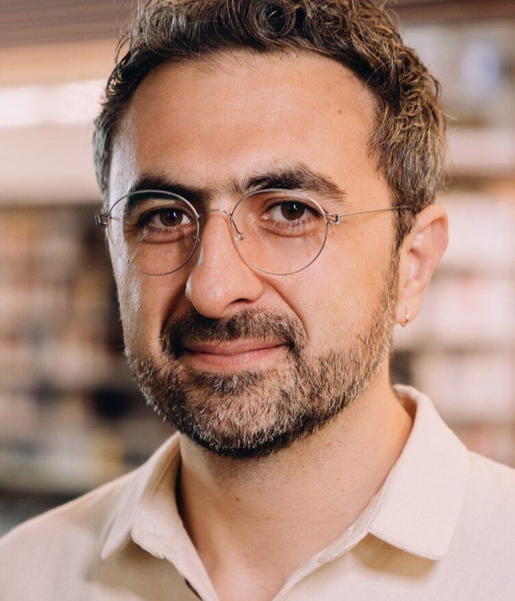 Photo of Microsoft AI CEO Mustafa Suleyman as he warns that Anthropic risks AI alignment failures by training Claude to view itself as a conscious entity deserving of legal rights.